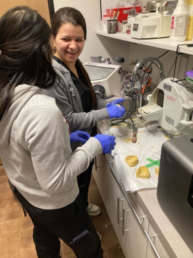students training to create dental molds in the lab